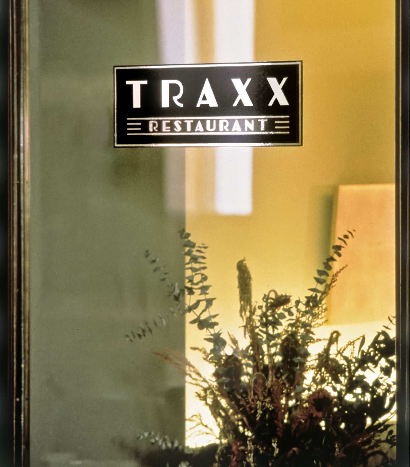 Traxx Restaurant window signage